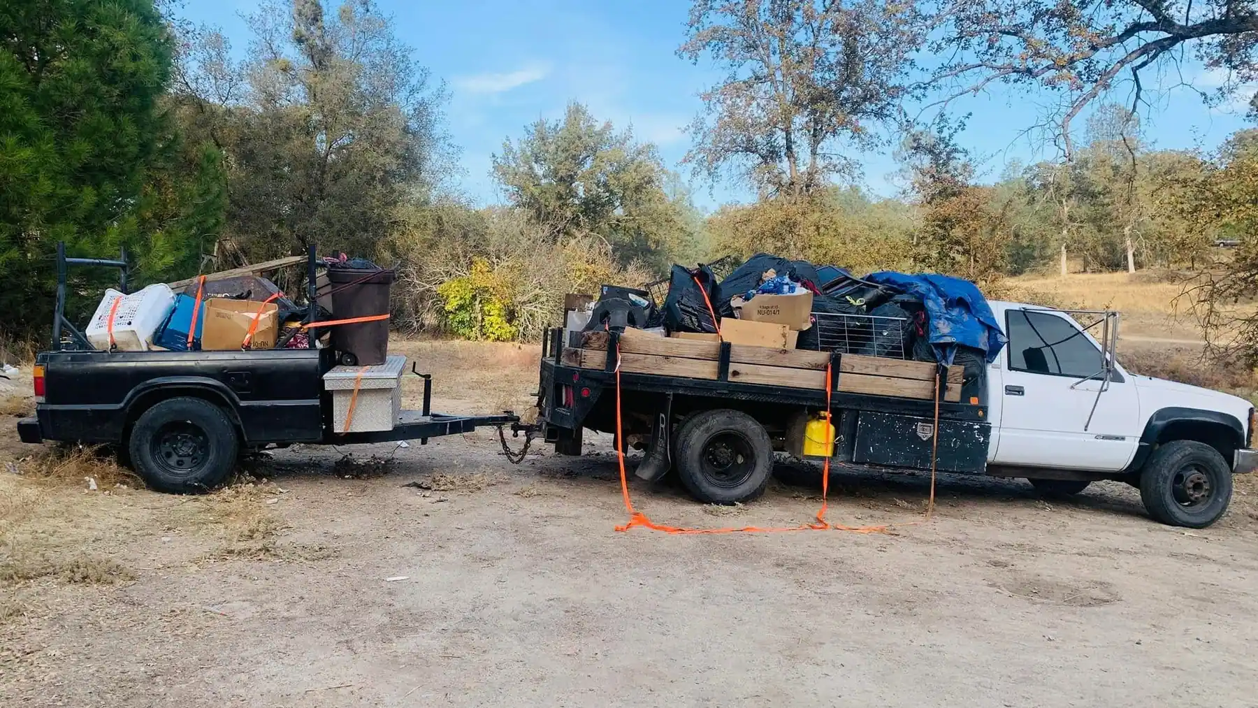 Brandon's pickup and trailer, both loaded to the rails with bins, boxes and bagged waste