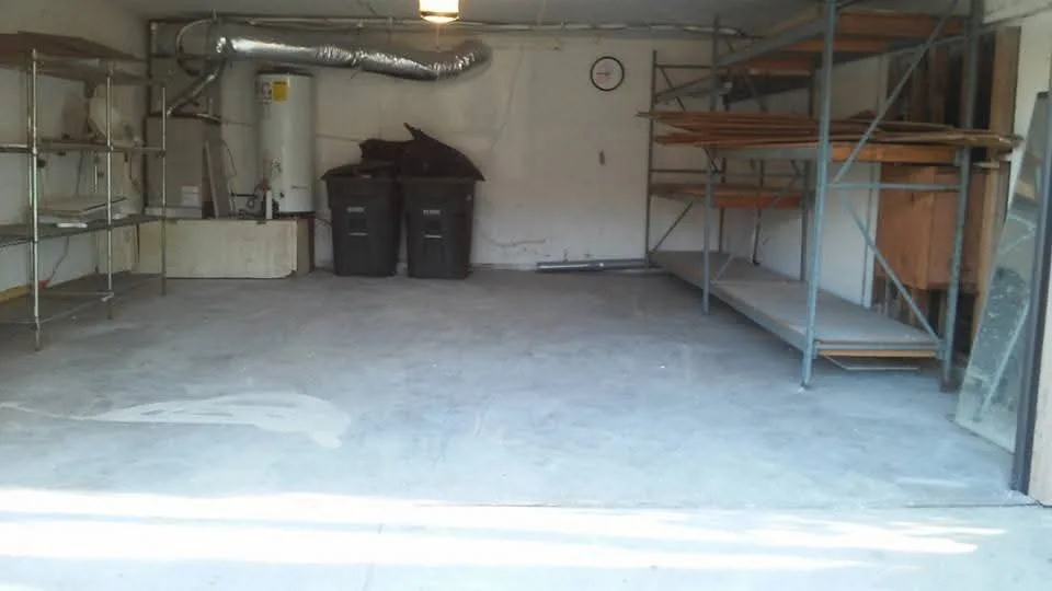 The same garage swept clean, with the floor and shelving clear again