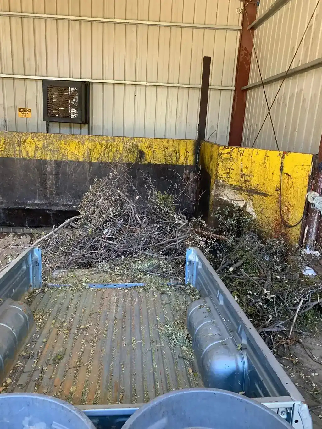 The truck bed swept out and empty after unloading at a transfer station