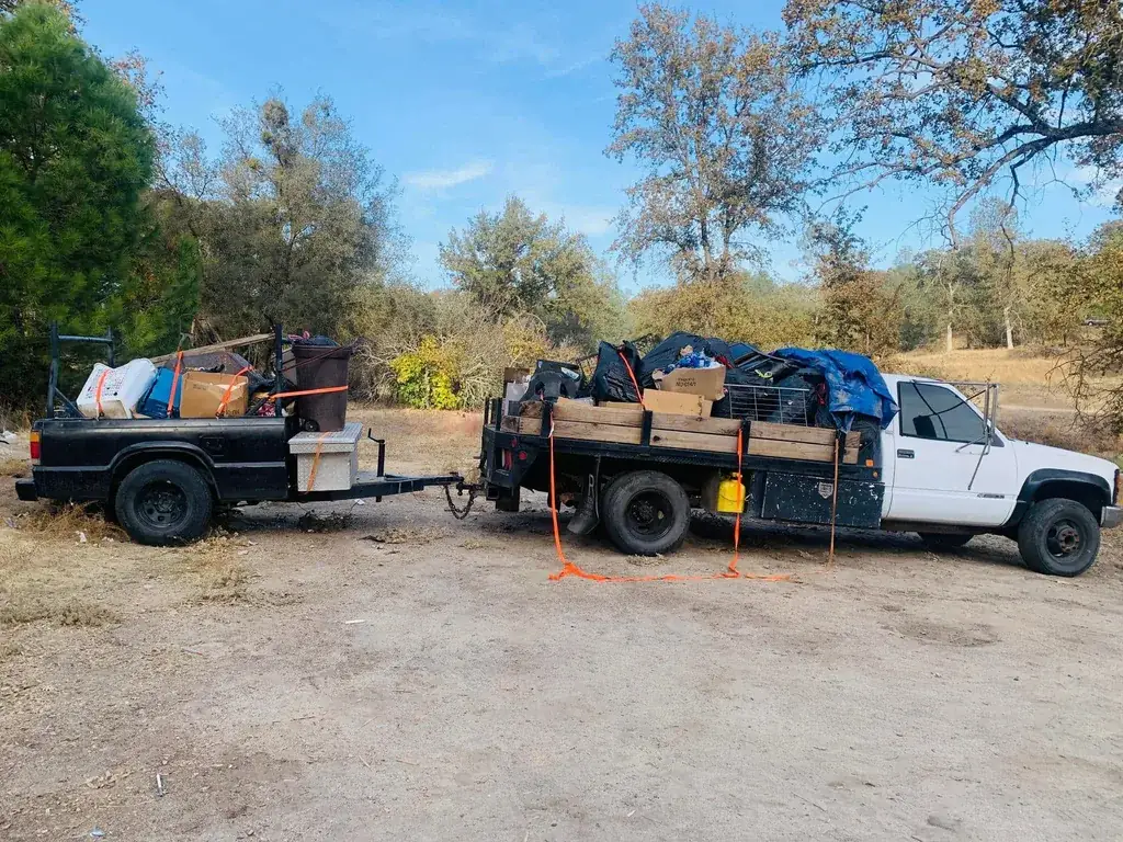 Two trucks loaded to the top with a full property cleanout